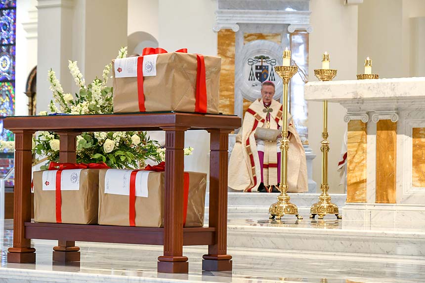 Three boxes of documents, ready to be sent to the Vatican, sit near the altar and represent six years of investigative work into the life of Father Thomas Price.