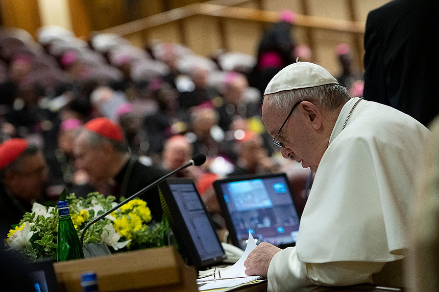 Pope Francis reviews papers during the third-day of a meeting on the protection of minors in the church at the Vatican Feb. 23, 2019. (CNS photo/Vatican Media)