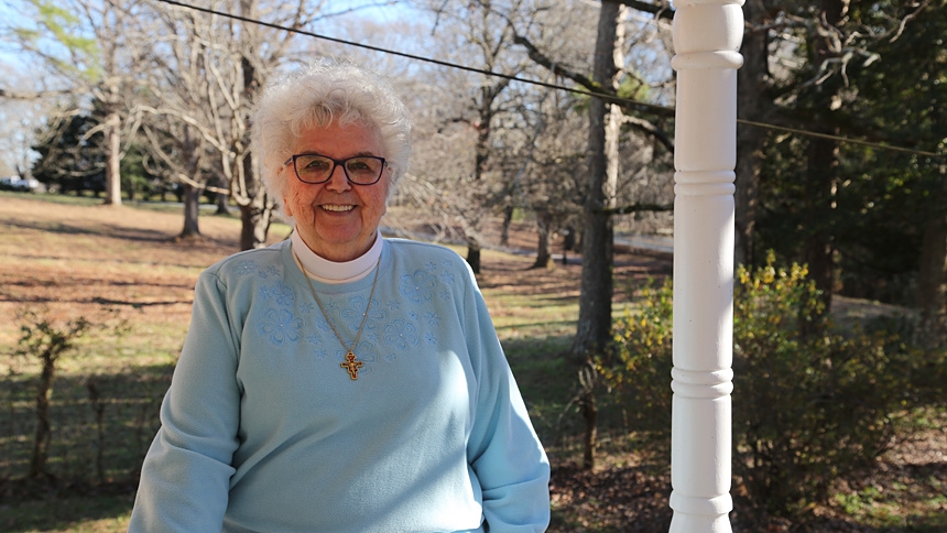Sister Damian Jackson, O.S.F., 87, stands on the porch of her Durham home near Avila Retreat Center, where she served as director for three decades. This year Sister Damian celebrates her 65th jubilee.