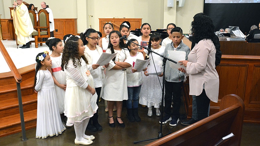 Children sing at St. Stephen the First Martyr Church during its Mass of dedication.