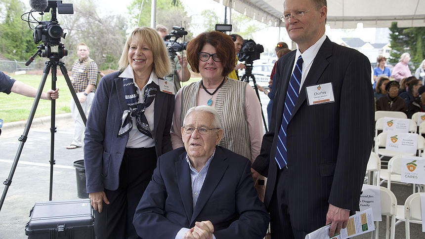 (Left to right) Trish Healy, co-chair of the Oak City Cares Steering Committee, Barbara Goodmon, honorary co-chair, Charles Meeker, co-chair, and Ron Doggett (front), honorary co-chair, smile at the April 8 ribbon cutting program for Oak City Cares. 