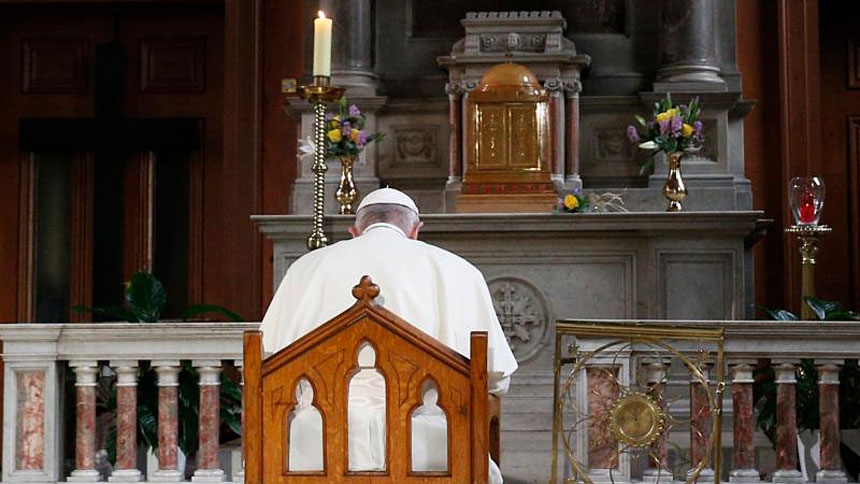 Pope Francis prays in front of a candle in memory of victims of sexual abuse as he visits St. Mary's Pro-Cathedral in Dublin Aug. 25, 2018.