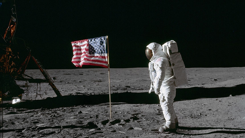 Astronaut Edwin "Buzz" Aldrin, lunar module pilot of the first lunar landing mission, poses for a photograph beside the deployed U.S. flag during an Apollo 11 extra-vehicular activity on the lunar surface July 20, 1969.