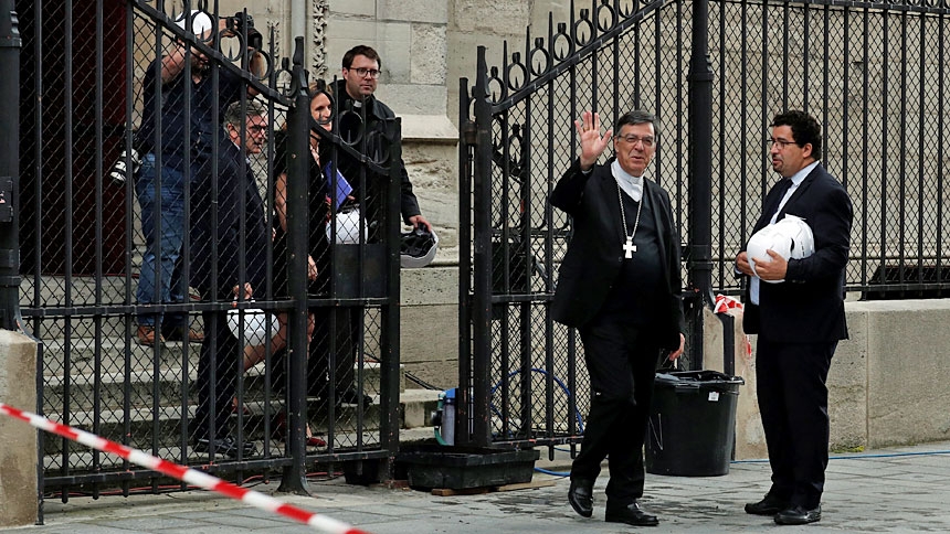 Archbishop Michel Aupetit of Paris waves after celebrating Mass in the Chapel of the Virgin inside Notre-Dame Cathedral June 15, 2019. It was the first Mass since a huge blaze devastated the landmark building in April. (CNS photo/Benoit Tessier, pool via Reuters)
