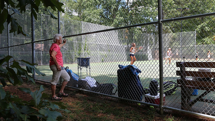 : Joan Monti, who was Forbes’ confirmation sponsor, watches her play tennis July 22 in Cary. Credit: by Kate Turgeon Watson