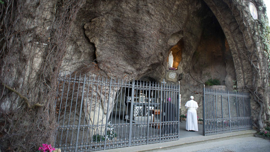 Pope Francis prays at a replica of the Lourdes Grotto in the Vatican Gardens in this 2013 file photo. Pope Francis will pray there May 30, the eve of Pentecost, leading the major shrines around the world in praying the rosary to implore Mary's intercession and protection amid the coronavirus pandemic. (CNS photo/L'Osservatore Romano) 