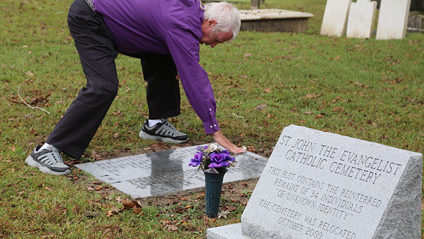 Mother of Mercy parishioner Larry McDaniel oversees the creation and placement of a grave marker in Washington, NC.