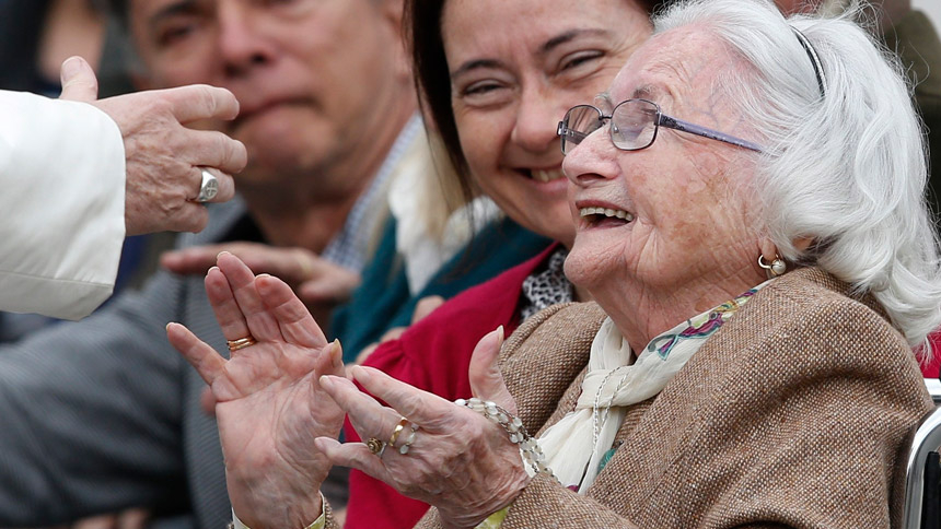 An elderly woman reacts as she meets Pope Francis during his general audience in St. Peter's Square at the Vatican in this March 22, 2017, file photo. The pope has chosen the theme "I am with you always," for the first World Day for Grandparents and the Elderly, to be celebrated July 25. (CNS photo/Paul Haring)