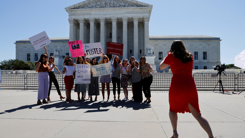 Women pose for a picture near the U.S Supreme Court building in Washington June 17, 2021. In a unanimous decision June 17, the Supreme Court said that a Catholic social service agency should not have been excluded from Philadelphia's foster care program because it did not accept same-sex couples as foster parents. (CNS photo/Jonathan Ernst, Reuters)