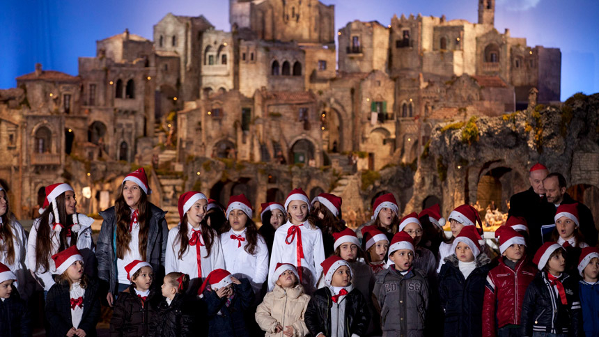 Children sing in front of the Nativity scene during its unveiling in St. Peter's Square at the Vatican on Christmas Eve Dec. 24, 2012. "O Holy Night" isn't just a carol, but a hymn of worship. (CNS photo/Paul Haring)