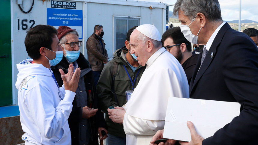 Pope Francis speaks with a man during a visit with refugees at the government-run Reception and Identification Center in Mytilene, Greece, Dec. 5, 2021. (CNS photo/Paul Haring)
