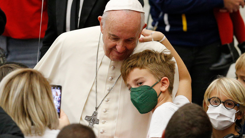 Pope Francis greets a boy during a meeting with children assisted by the Vatican's St. Martha pediatric clinic in the Paul VI hall at the Vatican Dec. 19, 2021. The pope offered Christmas blessings and urged the children to listen to and help people in need. (CNS photo/Paul Haring)