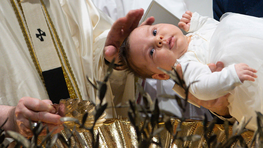 Pope Francis baptizes a baby as he celebrates Mass marking the feast of the Baptism of the Lord in the Sistine Chapel at the Vatican Jan. 9, 2022. The pope baptized 16 infants. (CNS photo/Vatican Media)