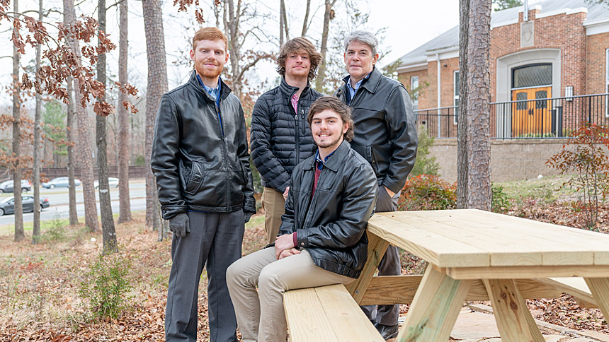 Wife and mother Laurie McNeil died shortly before her sons' projects were finished, but she was proud of them for pursuing the awards and championed their efforts during her lifetime. Here, her sons Colin (far left), Logan (back, middle) and Trevor (seated) and husband Eric (back, right) are pictured in 2022. (Photo by Maya Reagan)