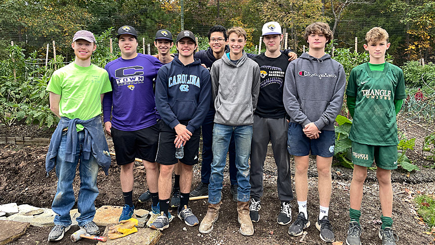 Baseball teammates of Trevor and Logan help with the projects in October 2021.