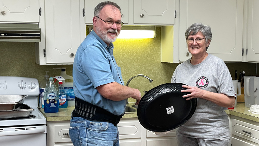 Armon and Sue Pfeifer help to clean the kitchen after the Friday Fish Fry at the St. John the Baptist Parish Hall in Roanoke Rapids March 25.