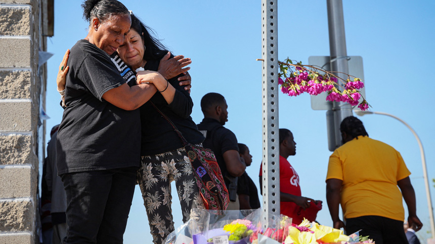 Mourners in Buffalo, N.Y., react May 15, 2022, while attending a vigil for victims of the shooting the day before at a TOPS supermarket. Authorities say the mass shooting that left 10 people dead was racially motivated. (CNS photo/Brendan McDermid, Reuters)