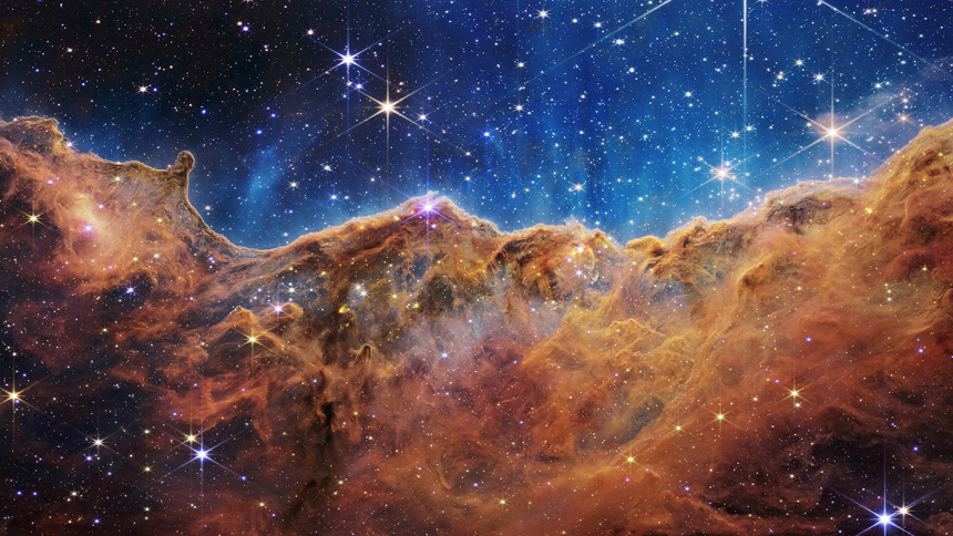 The "Cosmic Cliffs" of the Carina Nebula are seen in an image released by NASA released July 12, 2022. The "cliffs" are divided horizontally by an undulating line between a cloudscape forming a nebula along the bottom portion and a comparatively clear upper portion. (CNS photo/NASA, ESA, CSA, STScI, Webb ERO Production Team, Handout via Reuters)