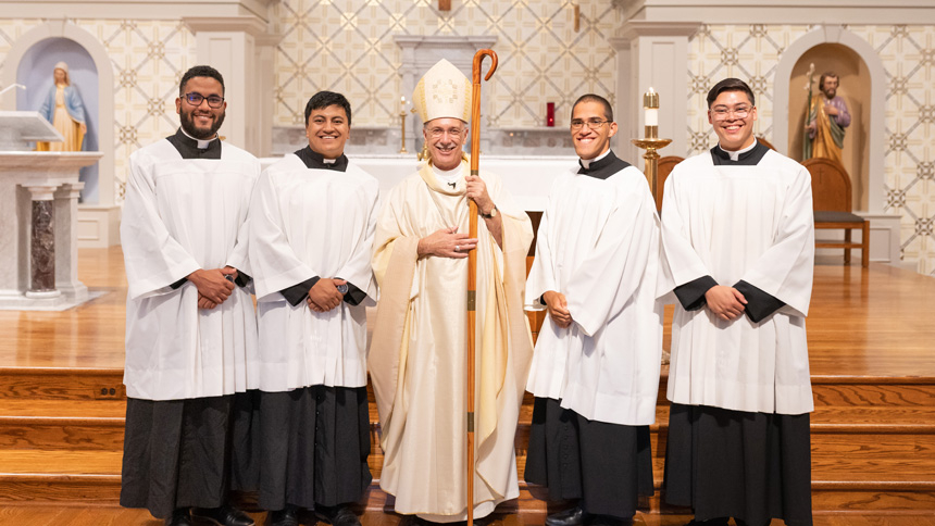 left to right: Jesus Alfredo Julio Tovar, Bairon Guerrero, Bishop Luis Rafael Zarama, Anthony May and Gabriel Nugent stand together after Mass Aug. 4 at St. Michael.