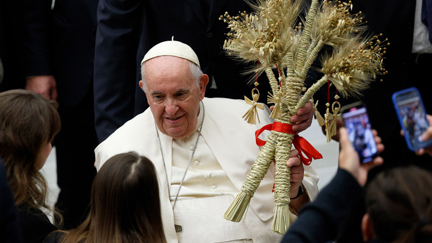 Pope Francis holds a gift during his general audience in the Paul VI hall at the Vatican Dec. 21, 2022. (CNS photo/Paul Haring)