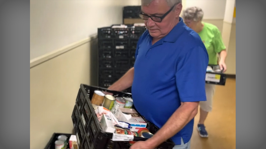 Friar Tim Lyons helps with an incoming shipment of items for the parish’s Little Portion Food Pantry.