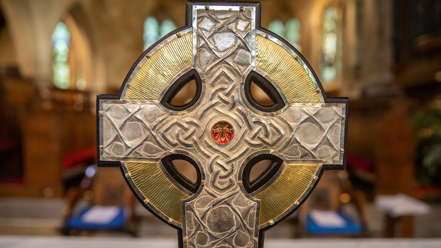 The top of the processional cross that will be used at the coronation of King Charles III in May is seen on the altar of an Anglican parish in Llandudo, Wales, April 19, 2023. Relics of the Christ's cross, a gift from Pope Francis, are under glass in the center of the processional cross. (CNS photo/Dave Custance, courtesy of the Church in Wales)