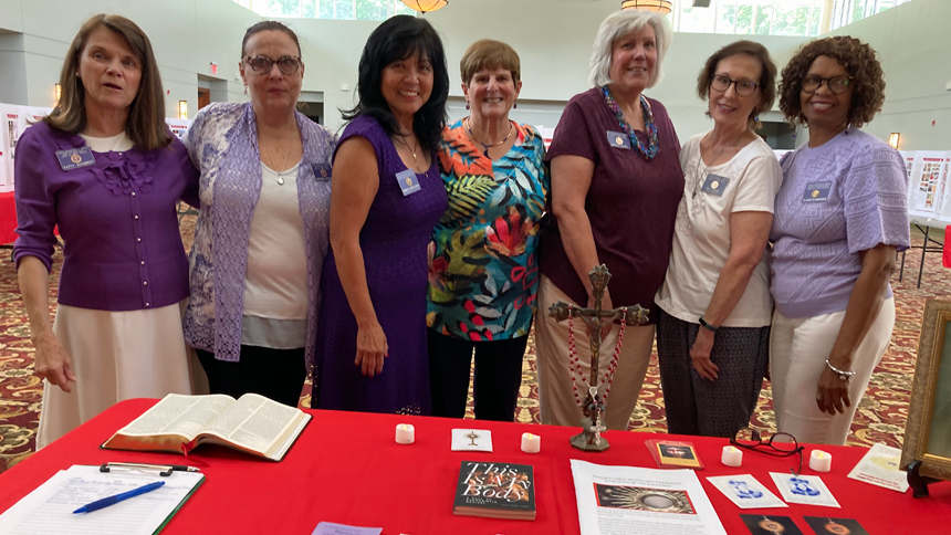 (Left to right) Patty Schubert, Barbara Brucato, Debbie del Corro El-Chayeb, Barbara Layton, Marcy Derby, MJ Lewis and Claudette Morrison volunteer at the exhibit in June. The exhibit will be on display at the Eucharistic Congress in October. 