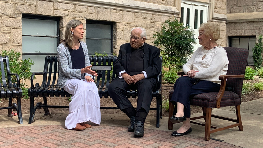Monsignor Lewis and Anne Stahel talk with Lewis Award recipient Kim Wheeler (far left) at Catheral School in 2023.
