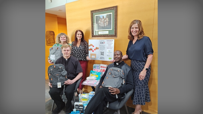 Clergy and staff of St. Mary Magdalene Church and School in Apex help to gather donated items, such as backpacks. It’s part of an effort to serve others and celebrate the diocesan centennial.
