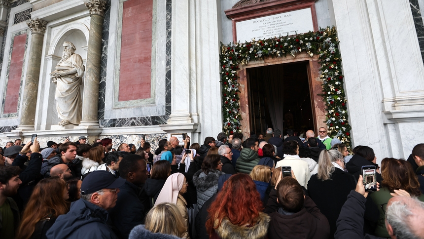 Visitors walk through the Holy Door of the Basilica of St. Paul Outside the Walls in Rome Jan. 5, 2025, after its ceremonial opening by U.S. Cardinal James M. Harvey, archpriest of the Basilica. The event marked the beginning of the Holy Year of 2025. (CNS photo/Lola Gomez)