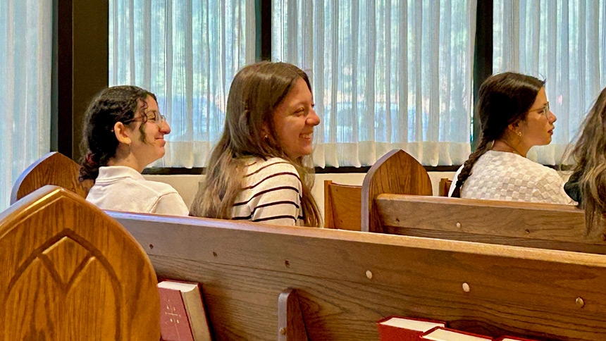 A Gibbons senior smiles during the homily by Bishop Luis.
