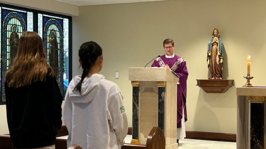 Father Luke Rawicki, L.C., chaplain at Cardinal Gibbons High School, reads the Gospel during Mass at the Catholic Center’s chapel March 25.