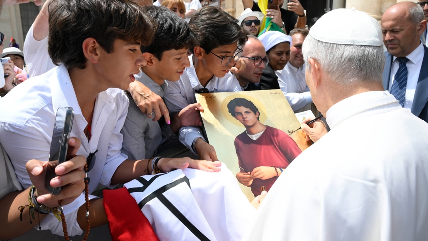 Pope Leo XIV signs an image of Blessed Carlo Acutis in St. Peter's Square after his general audience at the Vatican June 18, 2025. (CNS photo/Vatican Media)