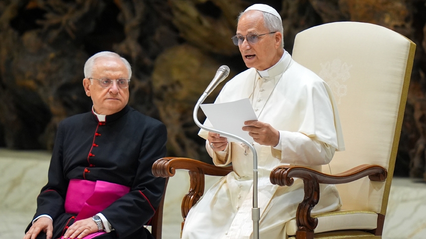 Pope Leo XIV talks to visitors during his weekly general audience in the Paul VI Audience Hall at the Vatican Aug. 20, 2025. (CNS photo/Lola Gomez)