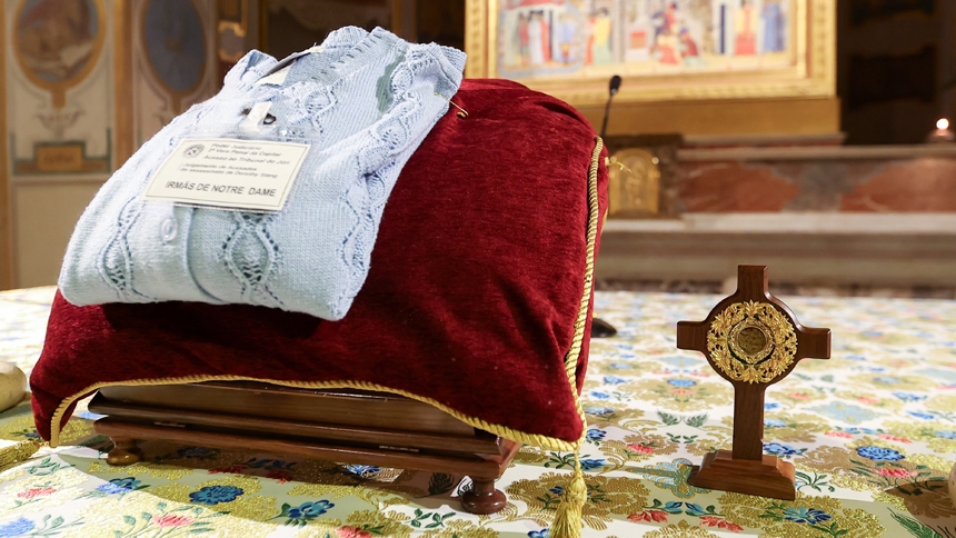 A cross containing blood-stained dirt from the site in the Amazon where Notre Dame de Namur Sister Dorothy Stang was killed in 2005, along with one of her sweaters, sits on the main altar before a prayer service at the Church of St. Bartholomew on Tiber Island in Rome Jan. 10, 2025. (CNS photo/Lola Gomez)