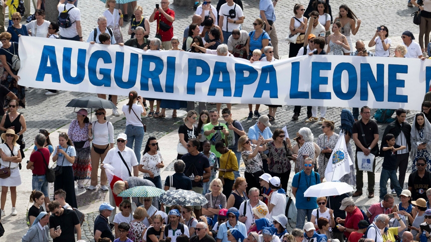 A group of people holds a sign wishing Pope Leo XIV a happy birthday as they join the pope for the recitation of the Angelus prayer in St. Peter's Square at the Vatican Sept. 14, 2025. (CNS photo/Vatican Media)