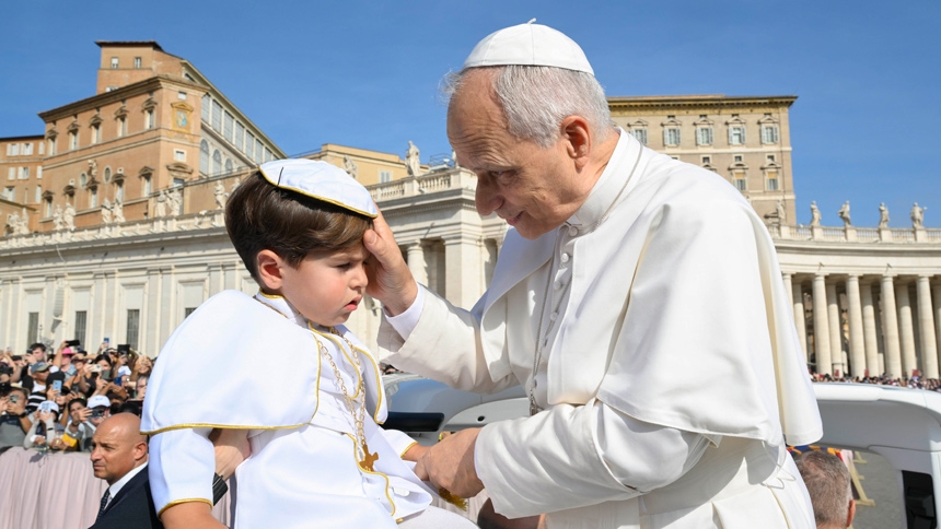 Pope Leo XIV greets a child dressed as the pope as he rides in the popemobile during the weekly general audience in St. Peter's Square at the Vatican Sept. 17, 2025. (CNS photo/Vatican Media)