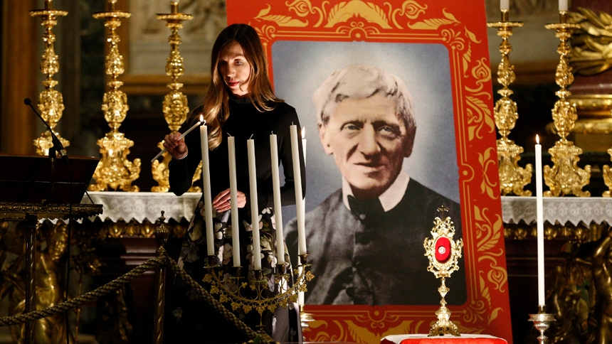 Melissa Villalobos of Chicago lights a candle during a vigil prior to the canonization of St. John Henry Newman at the Basilica of St. Mary Major in Rome, Oct. 12, 2019. Villalobos' healing through the intercession of St. John Henry Newman was accepted as the miracle necessary for the British cardinal's canonization. (CNS photo/Paul Haring)