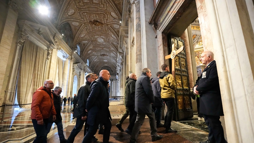 Pilgrims walk through the Holy Door at St. Peter’s Basilica at the Vatican Jan. 5, 2026, the last day it remained open before Pope Leo XIV officially closed it Jan. 6 to mark the end of the Holy Year. The pilgrim group was made up of members of the "Ispettorato di Pubblica Sicurezza Vaticano," the Italian police office at the Vatican State that helps protect the pope and provide security in Vatican City. (CNS photo/Lola Gomez)