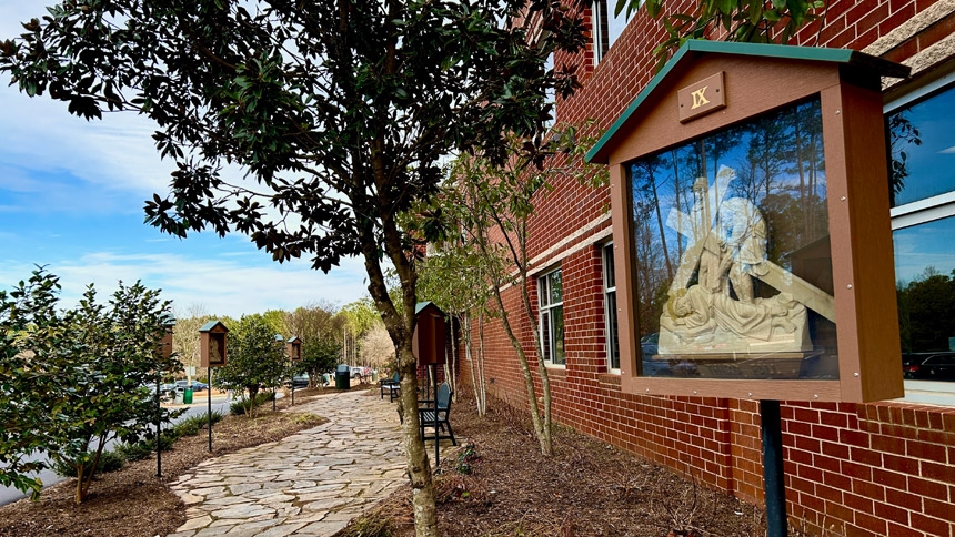 Theology students at Cardinal Gibbons High School in Raleigh visit the school’s outdoor Stations of the Cross with their classmates during Lent. 