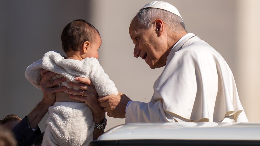 Pope Leo XIV greets a child from the popemobile while riding around St. Peter’s Square at the Vatican before his weekly general audience April 8, 2026. (CNS photo/Lola Gomez)