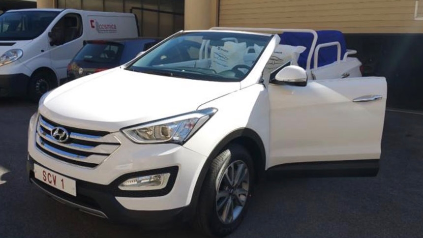 Archbishop Luis Marín de San Martín, head of the Dicastery for the Service of Charity, hands the popemobile key over to Michele Sagarino, president of Cross Catholic Outreach, April 28, 2026, at the Vatican. (CNS photo/courtesy of Cross Catholic Outreach)
