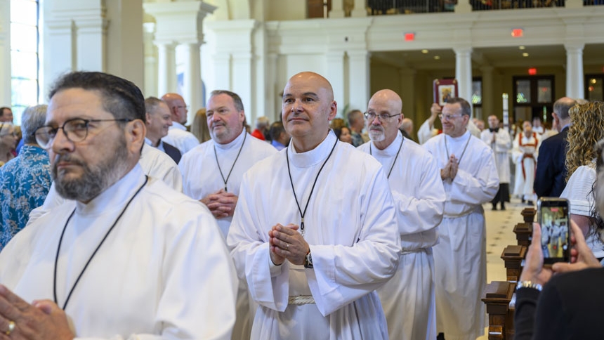 Candidates process into cathedral June 27.