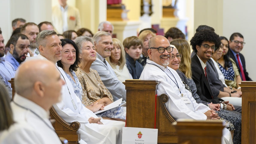 The congregation reacts to the bishop's homily.