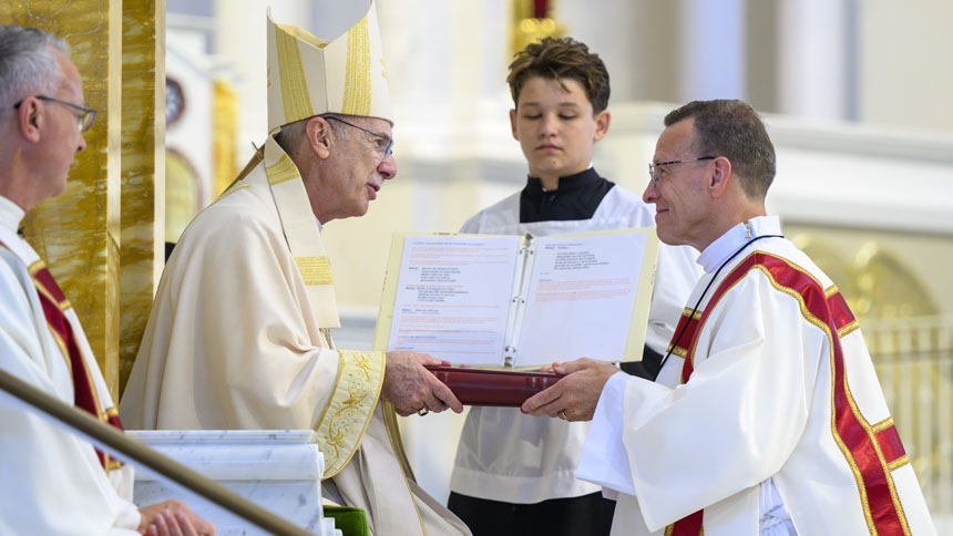 Deacon Joseph Werner receives the Book of Gospels.