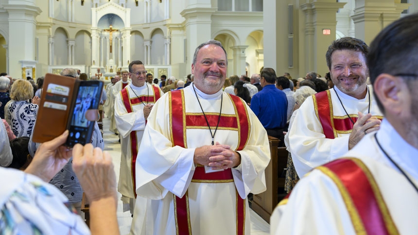 Deacon Matthew Sullivan (center) processes out of cathedral after Mass.