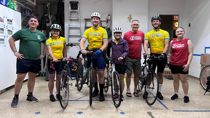 Joe Armen, Emma Ferrero, Jonathan Eger, Maddie Ferrero, Jim Scofield, Father Matthew Harrison and Karina Peplinski gather for a photo before the team launched from Raleigh.