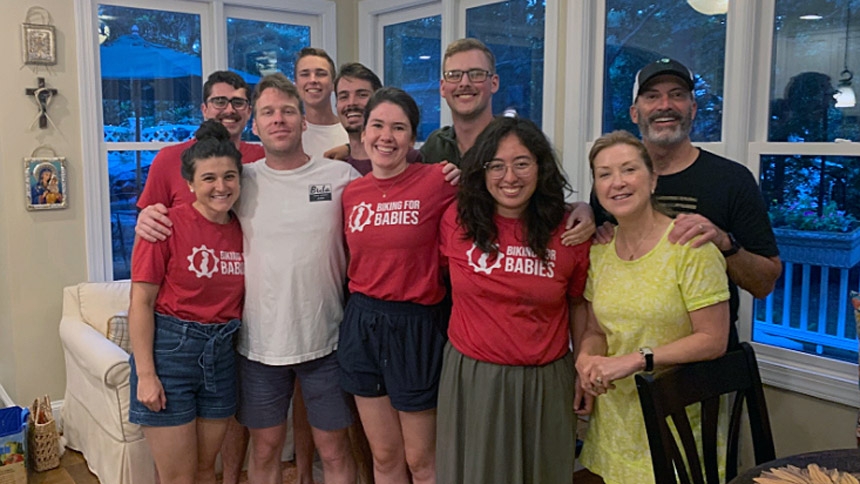 The 2025 team poses with hosts Ellen (in yellow) and John Guarente (far right).