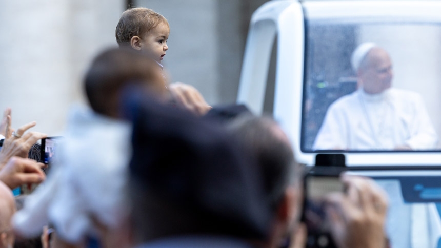 A child is held up for Pope Leo XIV to bless when he passes by in the popemobile during the general audience in St. Peter’s Square on Oct. 21, 2026. | Credit: Daniel Ibáñez/EWTN News