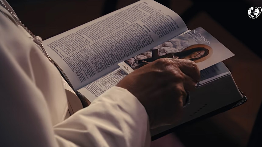 Pope Leo XIV holds a prayer card depicting St. Dymphna, patron saint for those with a mental illness, in a video of his prayer intention for October 2026, "For mental health ministry." (CNS screengrab/Pope's Worldwide Prayer Network)